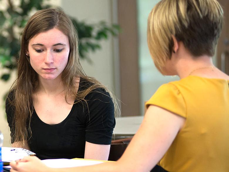 Female student receives help planning by female staff member