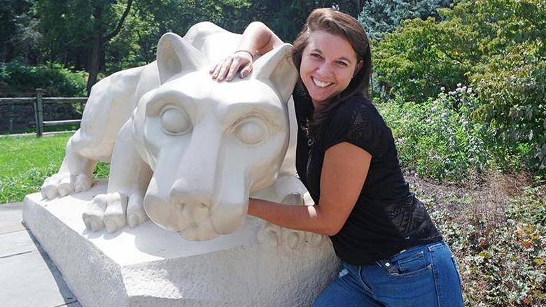 Courtney Stump poses with Lion Shrine at Penn State Mont Alto