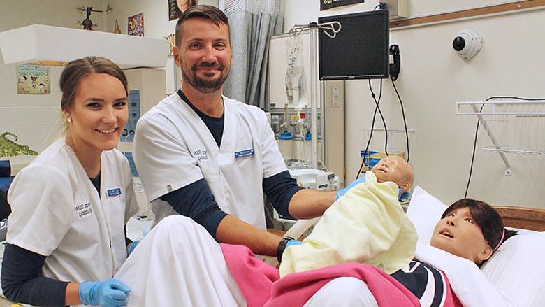 Nursing students participate in a birthing simulation with Lucina